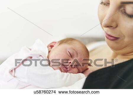 Baby sleeping on mother's chest View Large Photo Image Picture - Baby sleeping on mother's chest. Fotosearch