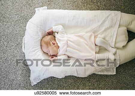 Baby sleeping on U-shaped pillow at home View Large Photo Image Stock Photography - Baby sleeping on U-shaped pillow at home. Fotosearch
