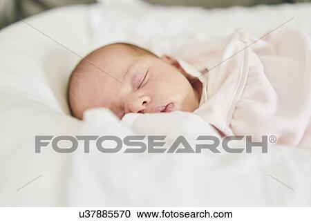 Stock Image - Baby sleeping on U-shaped pillow. Fotosearch