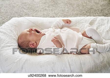 Baby yawning on U-shaped pillow at home View Large Photo Image Stock Photo - Baby yawning on U-shaped pillow at home. Fotosearch