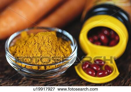 Stock Photo - Beta carotene supplement pills and vegetables. Fotosearch