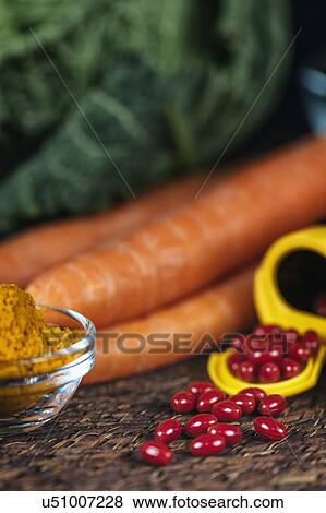 Beta carotene supplement pills and vegetables View Large Photo Image Stock Photo - Beta carotene supplement pills and vegetables. Fotosearch