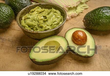 Picture - Bowl of guacamole with avocados. Fotosearch