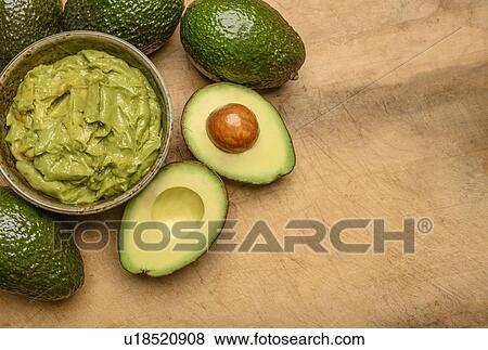 Stock Photo - Bowl of guacamole with avocados. Fotosearch