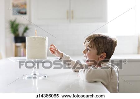 Boy reaching for birthday cake View Large Photo Image Stock Photography - Boy reaching for birthday cake. Fotosearch
