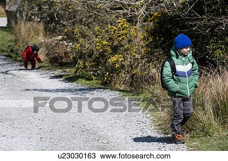 Stock Image - Boys exploring national park, Llanaber, Gwynedd, United Kingdom. Fotosearch
