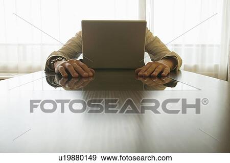Stock Photo - Businessman behind laptop. Fotosearch