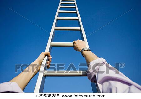 Businessman climbing a ladder View Large Photo Image Stock Photography - Businessman climbing a ladder. Fotosearch