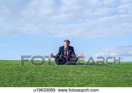 Stock Photography - Businessman in lotus position. Fotosearch