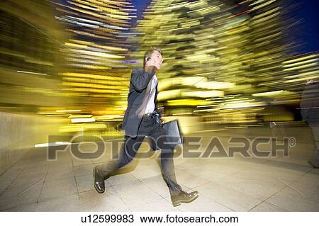 Businessman leaving the office at night View Large Photo Image Stock Image - Businessman leaving the office at night. Fotosearch