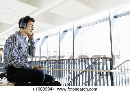 Stock Photo - Businessman using digital tablet in office. Fotosearch