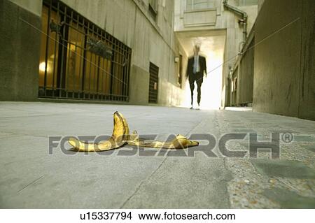 Businessman walking towards banana skin View Large Photo Image Picture - Businessman walking towards banana skin. Fotosearch