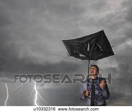 Businessman with broken umbrella in a storm View Large Photo Image Stock Photograph - Businessman with broken umbrella in a storm. Fotosearch