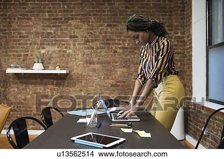 Businesswoman analysing work using laptop View Large Photo Image Picture - Businesswoman analysing work using laptop. Fotosearch