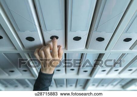 Stock Image - Businesswoman browsing archive files. Fotosearch