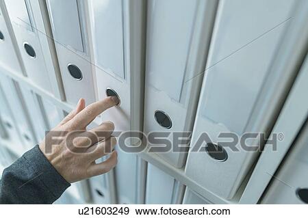 Stock Photo - Businesswoman browsing archive files. Fotosearch
