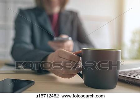 Businesswoman texting during coffee break View Large Photo Image Stock Image - Businesswoman texting during coffee break. Fotosearch