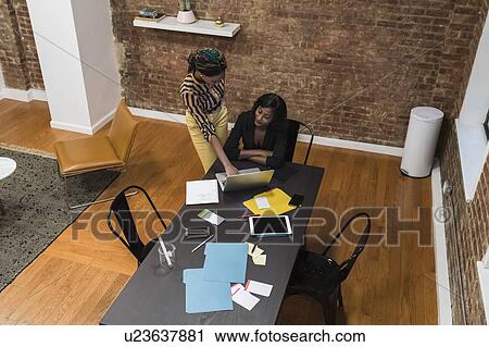 Businesswomen analysing work using laptop View Large Photo Image Stock Image - Businesswomen analysing work using laptop. Fotosearch