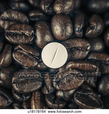 Picture - Caffeine supplement pill and coffee beans. Fotosearch