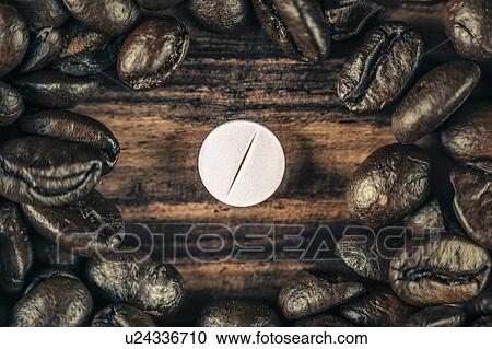 Stock Image - Caffeine supplement pill and coffee beans. Fotosearch