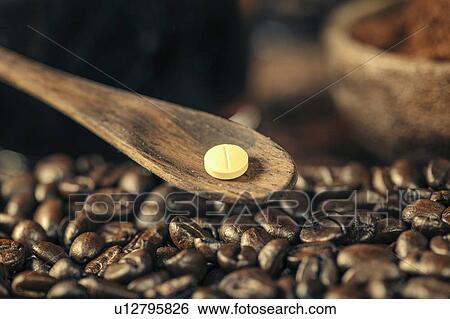 Stock Photograph - Caffeine supplement pill and coffee beans. Fotosearch