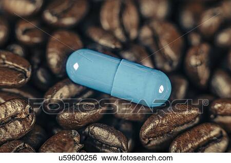 Stock Photograph - Caffeine supplement pill and coffee beans. Fotosearch