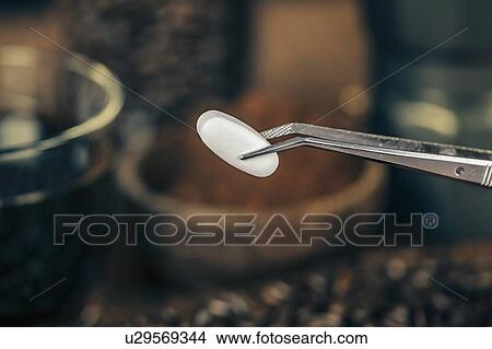 Picture - Caffeine supplementation pill. Fotosearch