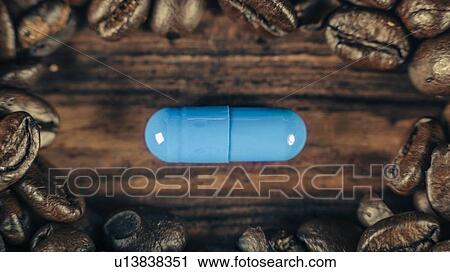Stock Image - Caffeine supplementation with coffee beans. Fotosearch
