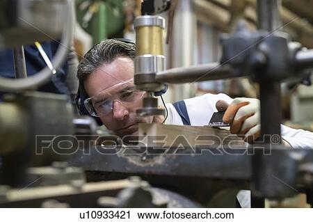 Carpenter working in factory View Large Photo Image Stock Image - Carpenter working in factory. Fotosearch
