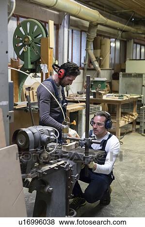 Stock Photo - Carpenters working in factory. Fotosearch