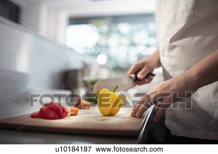 Stock Photo - Close up of chef making meal in development kitchen in food factory. Fotosearch