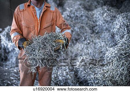 Close up of worker holding titanium swarf waste in titanium recycling plant View Large Photo Image Picture - Close up of worker holding titanium swarf waste in titanium recycling plant. Fotosearch