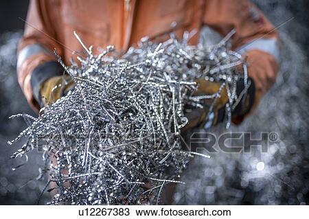 Close up of worker holding titanium swarf waste in titanium recycling plant View Large Photo Image Stock Image - Close up of worker holding titanium swarf waste in titanium recycling plant. Fotosearch