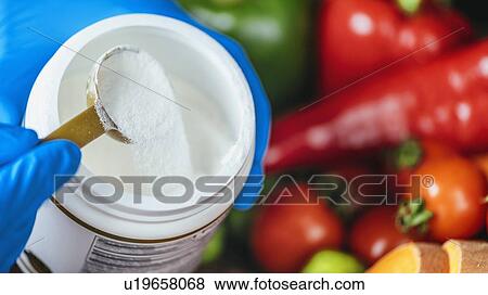Stock Photo - Collagen protein supplement powder and vegetables. Fotosearch