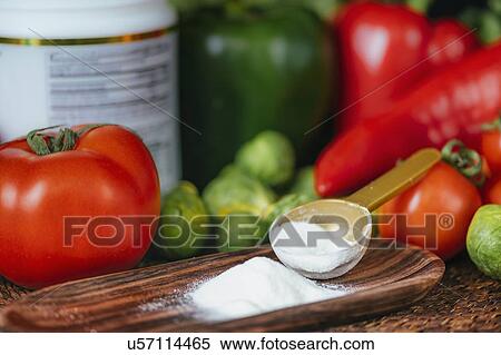 Stock Photography - Collagen protein supplement powder and vegetables. Fotosearch