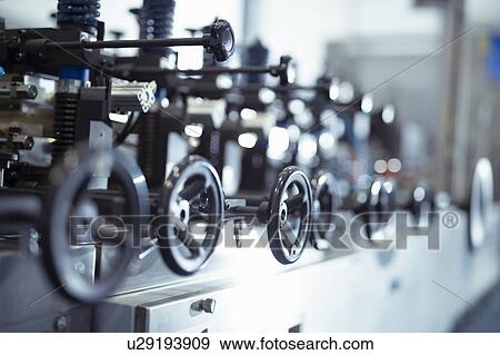 Control wheels on food packaging printing machine in print factory View Large Photo Image Stock Photo - Control wheels on food packaging printing machine in print factory. Fotosearch
