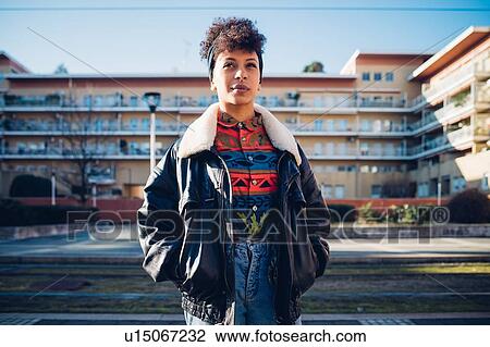 Cool young woman on urban sidewalk looking up, portrait View Large Photo Image Stock Image - Cool young woman on urban sidewalk looking up, portrait. Fotosearch