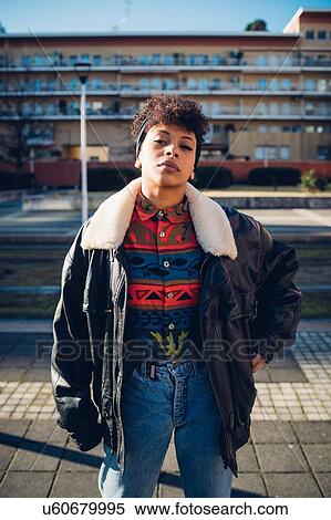 Cool young woman on urban sidewalk, portrait View Large Photo Image Stock Photography - Cool young woman on urban sidewalk, portrait. Fotosearch