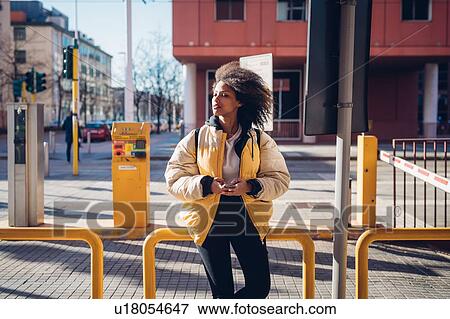 Cool young woman waiting at city tram station View Large Photo Image Stock Photo - Cool young woman waiting at city tram station. Fotosearch