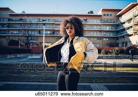 Cool young woman wearing sunglasses on urban sidewalk, portrait View Large Photo Image Stock Photo - Cool young woman wearing sunglasses on urban sidewalk, portrait. Fotosearch
