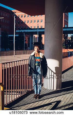 Cool young woman with standing on sunlit city sidewalk, portrait View Large Photo Image Stock Image - Cool young woman with standing on sunlit city sidewalk, portrait. Fotosearch