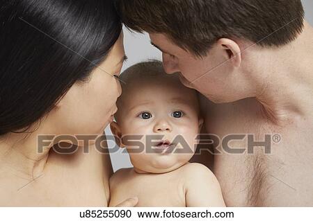 Stock Image - Couple and baby boy. Fotosearch
