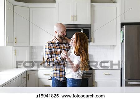 Couple dancing in kitchen View Large Photo Image Stock Photography - Couple dancing in kitchen. Fotosearch