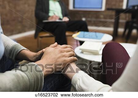 Stock Image - Couple having therapy at psychiatrist's office. Fotosearch