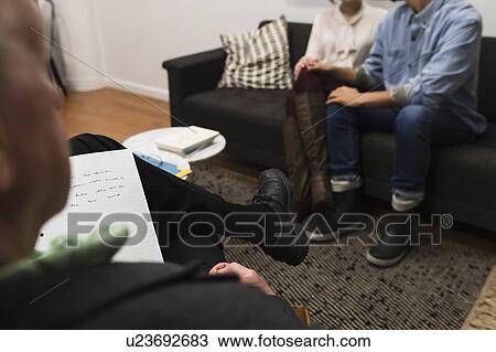 Stock Image - Couple having therapy at psychiatrist's office. Fotosearch