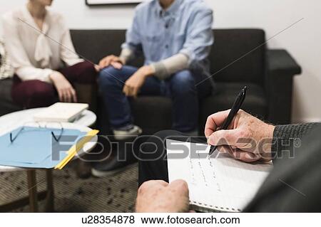 Stock Photo - Couple having therapy at psychiatrist's office. Fotosearch