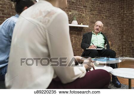 Stock Photography - Couple having therapy at psychiatrist's office. Fotosearch