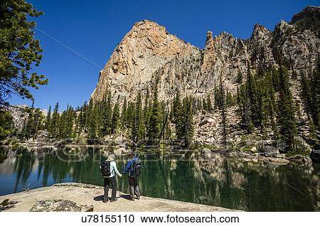 Couple holding hands by river in Sawtooth Mountains in Stanley, Idaho, USA View Large Photo Image Stock Image - Couple holding hands by river in Sawtooth Mountains in Stanley, Idaho, USA. Fotosearch