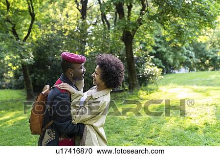 Stock Image - Couple hugging in park, Milan, Italy. Fotosearch