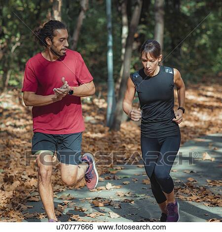 Couple jogging outdoors in park View Large Photo Image Stock Photograph - Couple jogging outdoors in park. Fotosearch